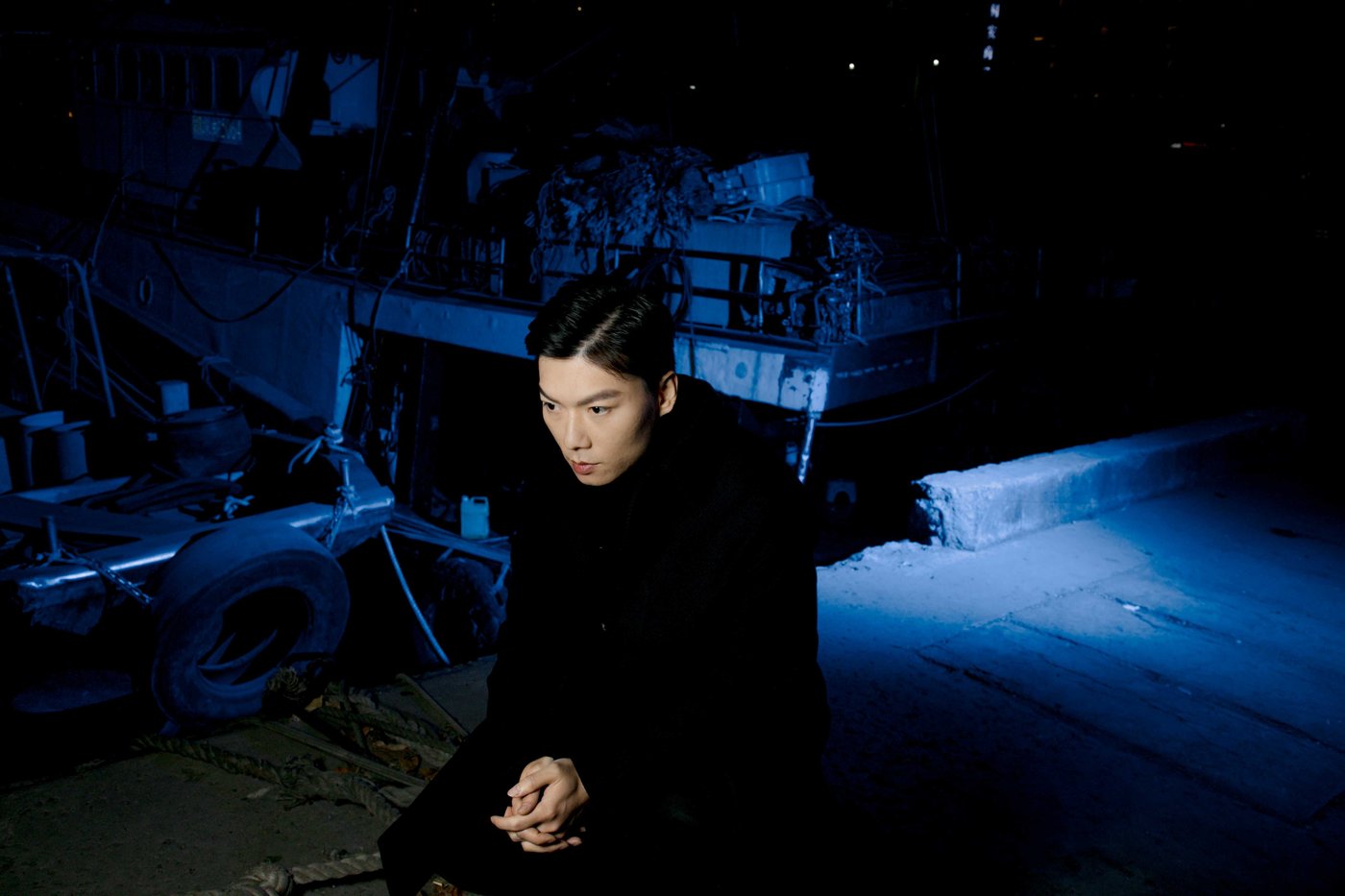Chen Qiufan photographed at a harbor for WIRED